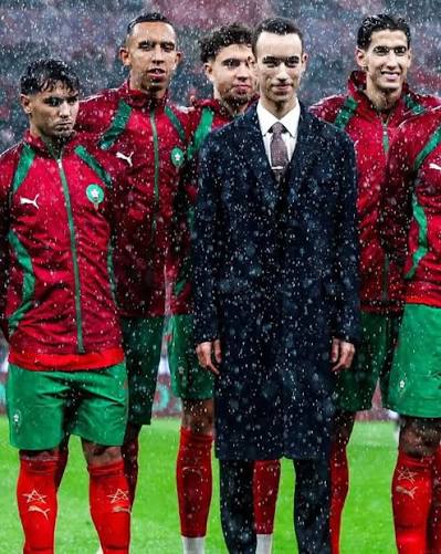 Crown Prince Moulay El Hassan stands with Atlas Lions players in the rain during the AFCON final ceremony at the Prince Moulay Abdellah Stadium in Rabat